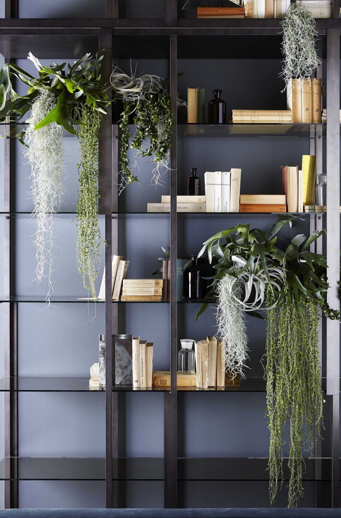 Tortona bookshelf with a modern design, featuring open shelving and a minimalist frame on a gray background.