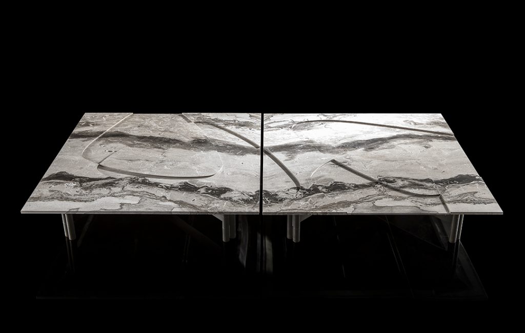 Background Coffee Table. White and gray marble top and four black legs on a black background.