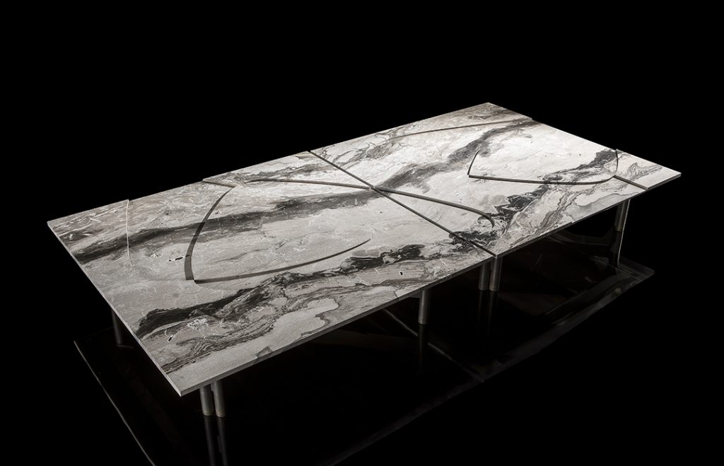 Background Coffee Table. White and gray marble top and four black legs on a black background.
