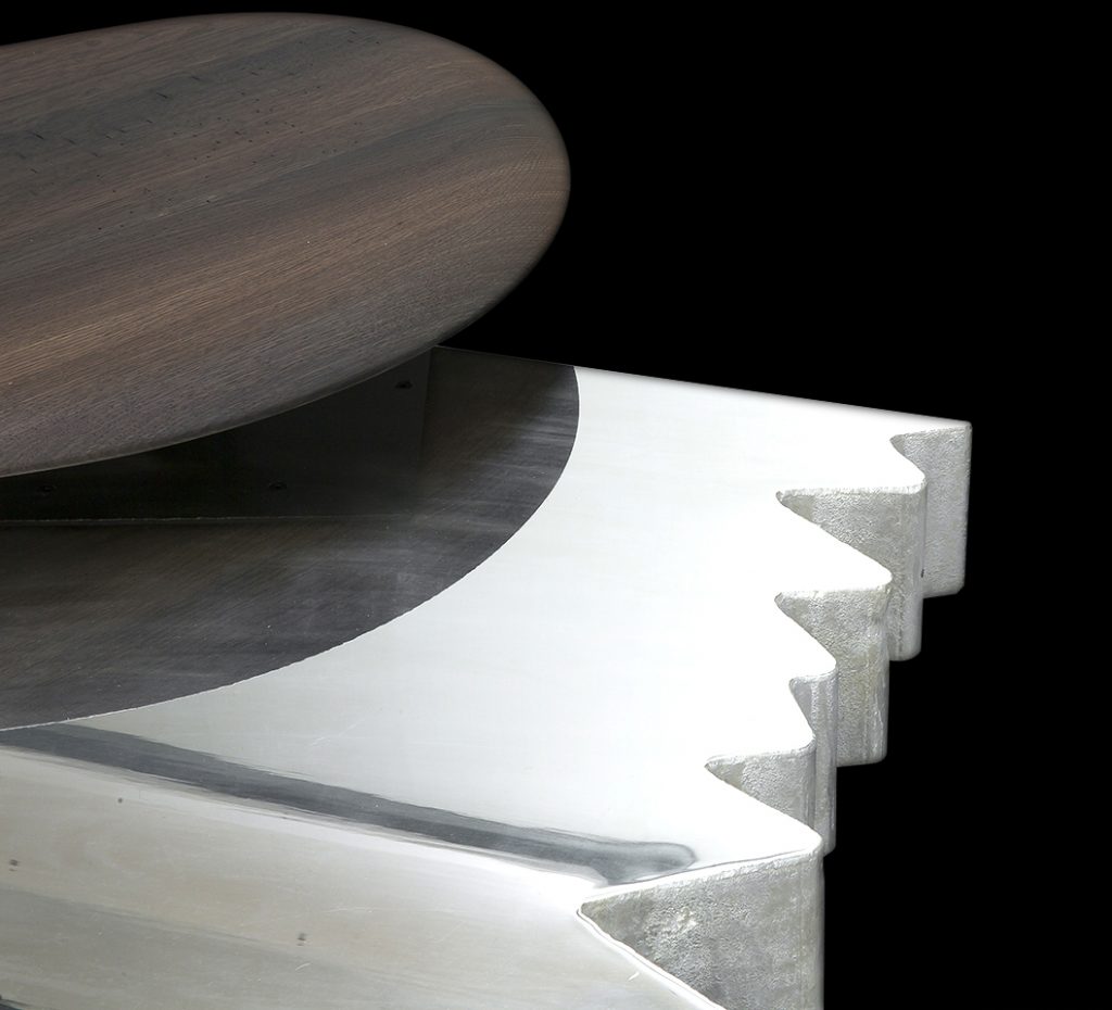 Closeup of rectangle Be Mine coffee table. Finish in silver with pointed edges on a black background.