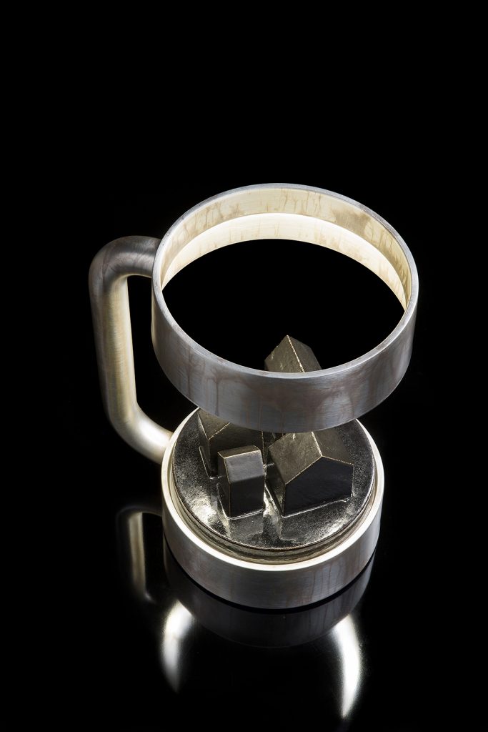 Compound Light silver finish structure and black stone design in the center on a black background.
