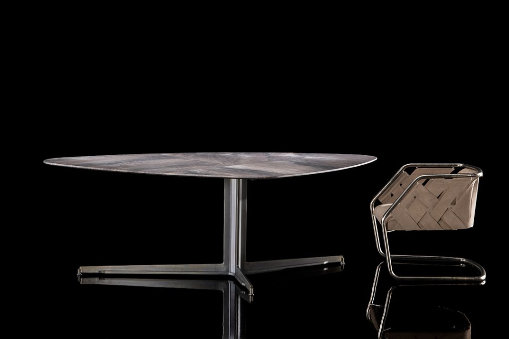Gibson Coffee Table, top in wood and black steel central leg on a black background.