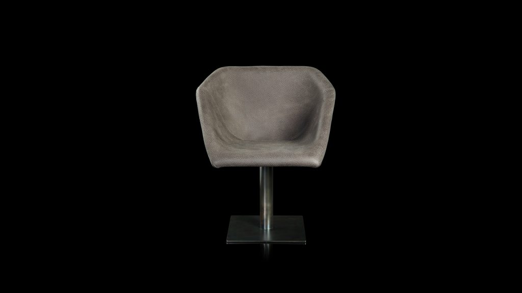 Hexagon chair, upholstered in gray leather and central leg finished in brass on a black background.