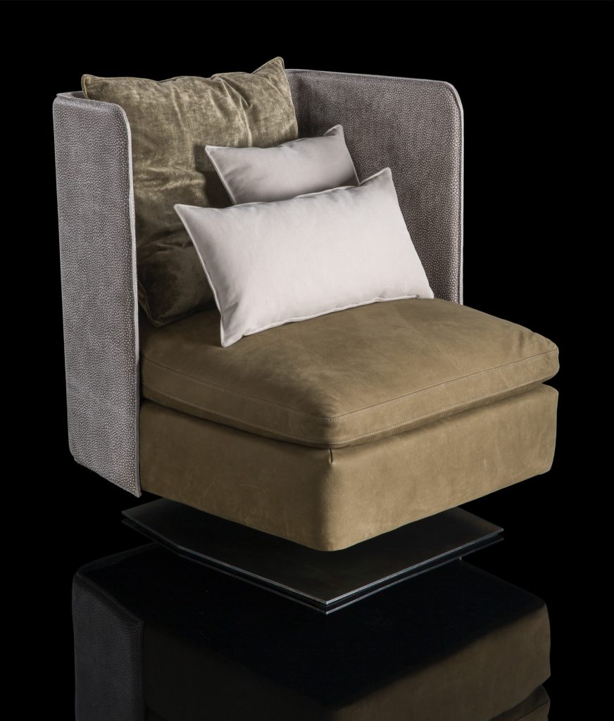 Human Armchair upholstered in brown leather and three gray cushions. Structure armchair with metal base frame and central leg on a black background.