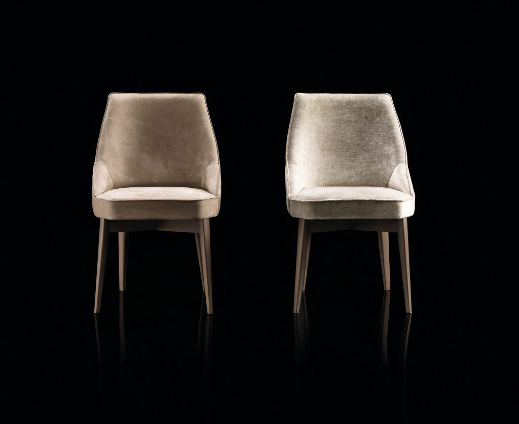 Two Is A Chair in gray fabric with for legs in black eucalyptus wood on a black background.