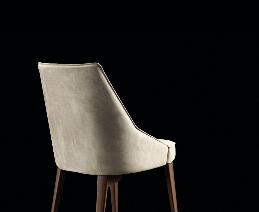 Is A Chair in gray fabric with for legs in black eucalyptus wood on a black background.