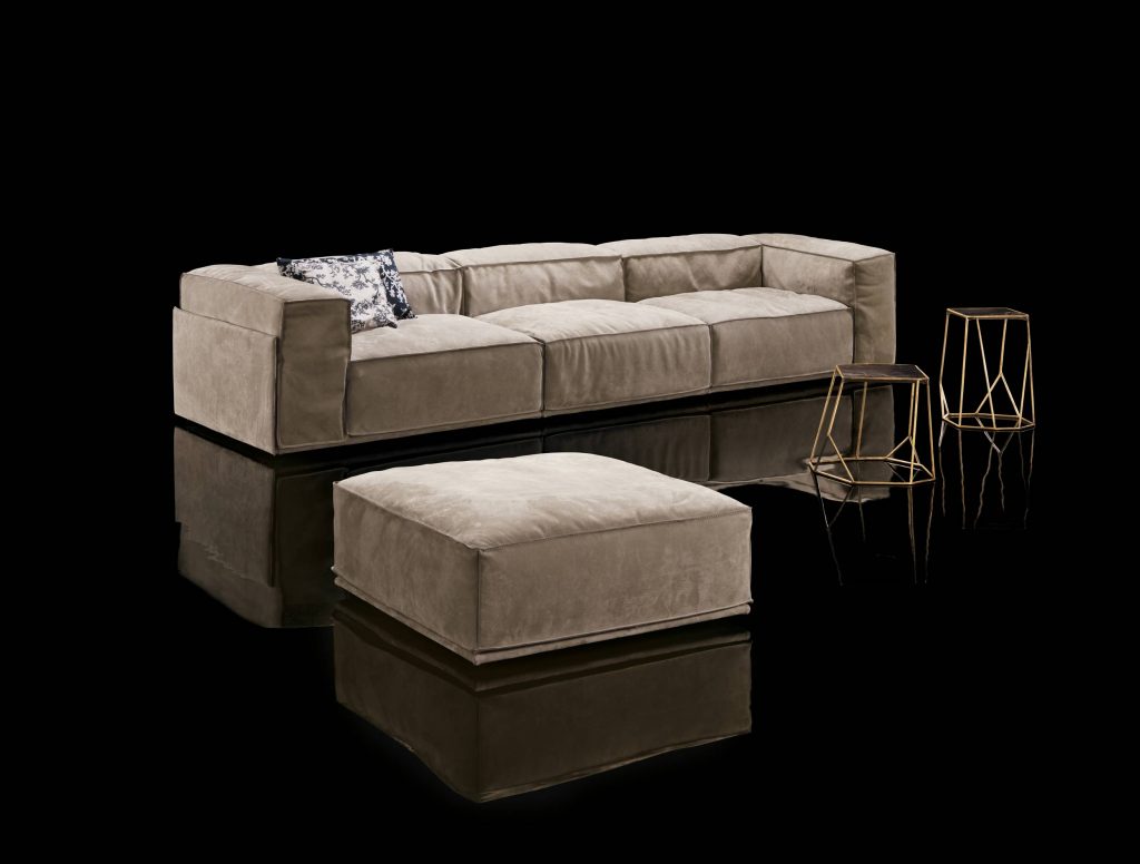 Three seater S-Perla Sofa with backrest and armrest upholstered in brown nappa on a black background.