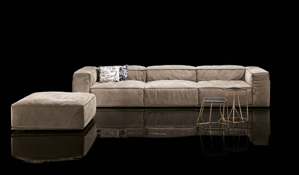 Three seater S-Perla Sofa with backrest and armrest upholstered in brown nappa on a black background.