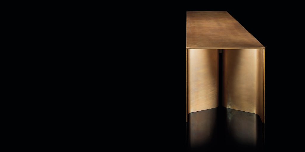 Time Table with two legs, structure in natural wood cover in burnished brass on a black background.