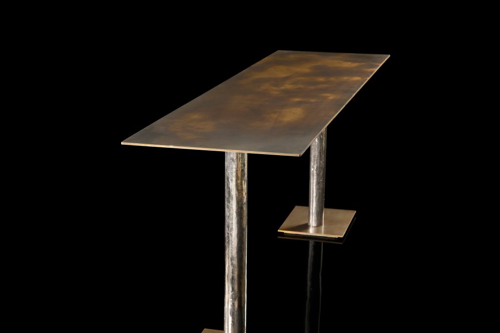 Rectangle Twistable Coffe Table And Consolle. Structure support in bronze, top in bronze metal and central leg in burnished titanio on a black background.