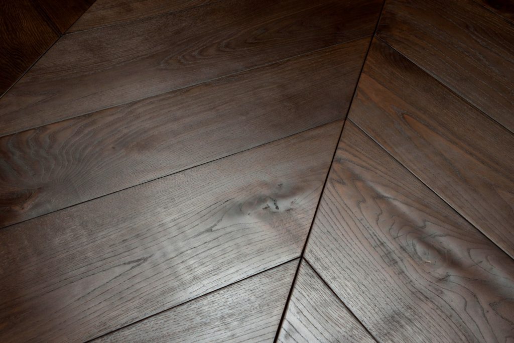 Historic wood finish in dark brown with a rustic, aged look.