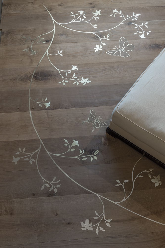 Inlay mosaics wood finish with black and gray flower like patterns.