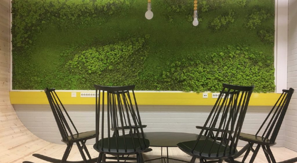 Moss Flex Element in green with textured patterns, on the wall in a restaurant.