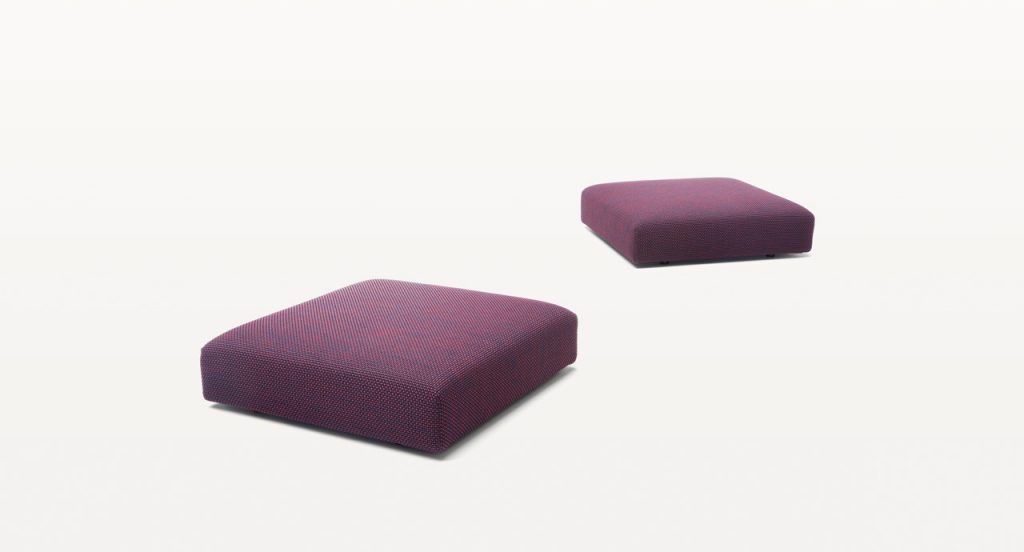 Two square Move Poufs, upholstery in purple fabrics on a white background.