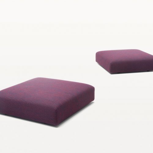 Two square Move Poufs, upholstery in purple fabrics on a white background.