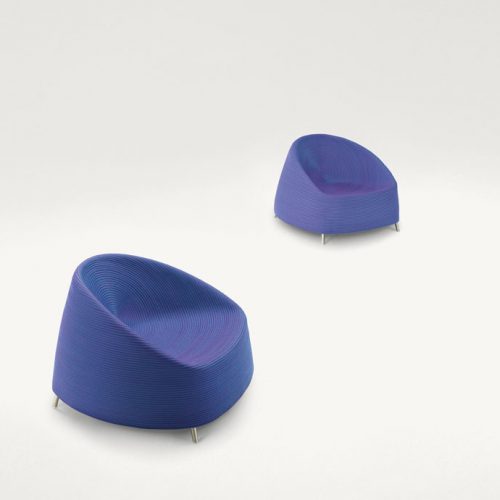 Two Afra Armchairs upholstered in blue purple cord sewn with a spiral-like pattern and four legs in steel on a white background.