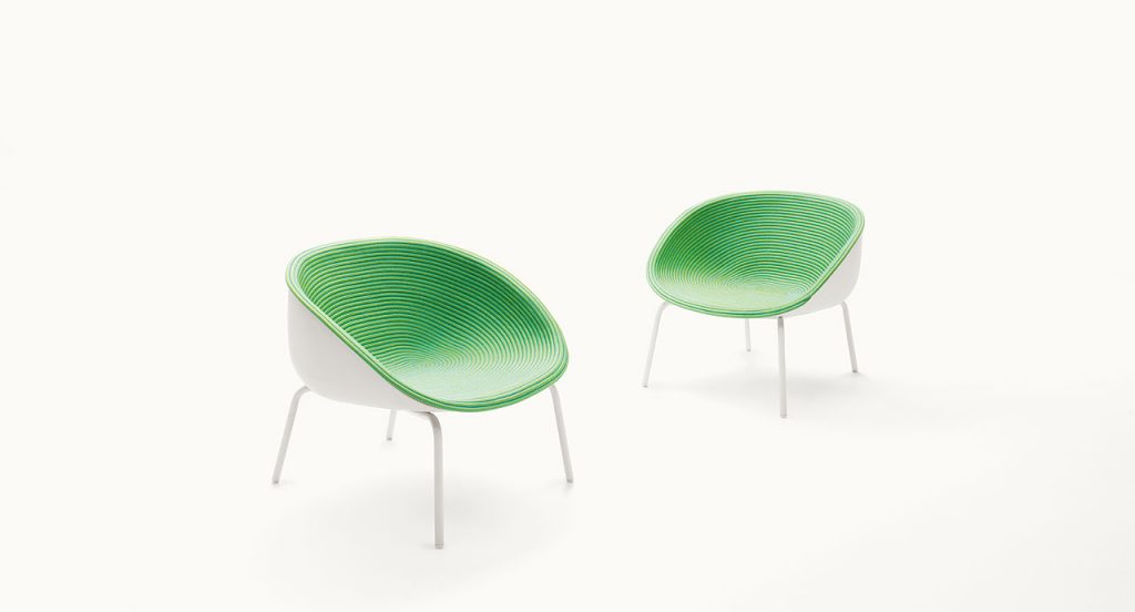 Two Amable Armchairs, four legs of white steel, white molded polyethylene shell and green rope cord cover on a white background.