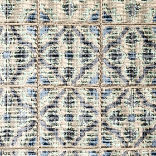 Donna Florio rug, embroidered with gray, blue, green and beige flat braids with a diamond like pattern.