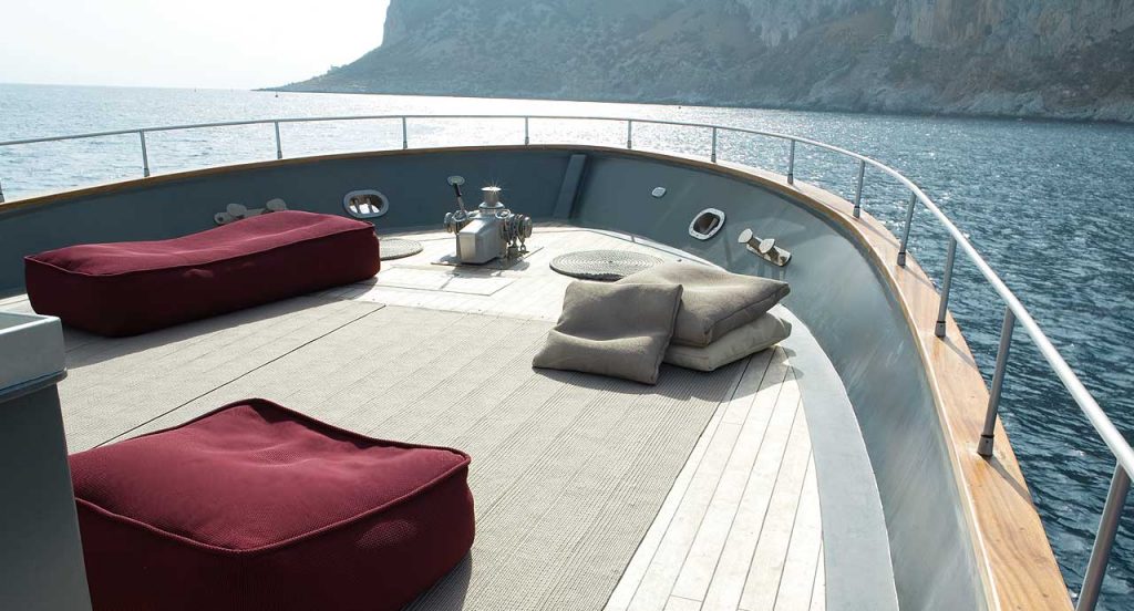 Two Float Outdoor Poufs, upholstery in red fabrics on a boat.