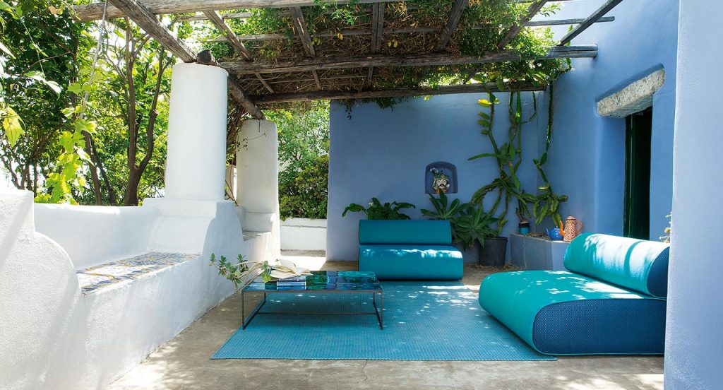 Two black and blue Ola Outdoor Sofas with backrest upholstery in fabric in a terrace.