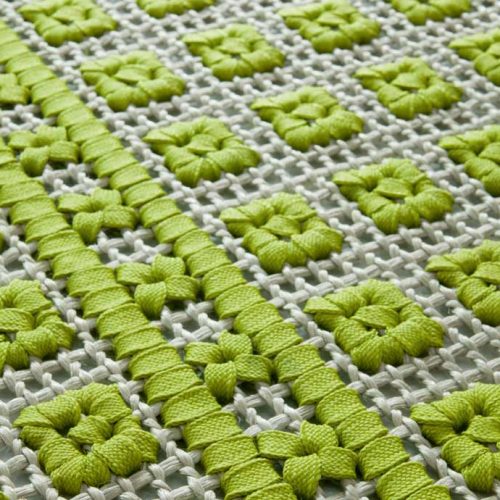Orto rug, embriodery made of white and green flat braids.