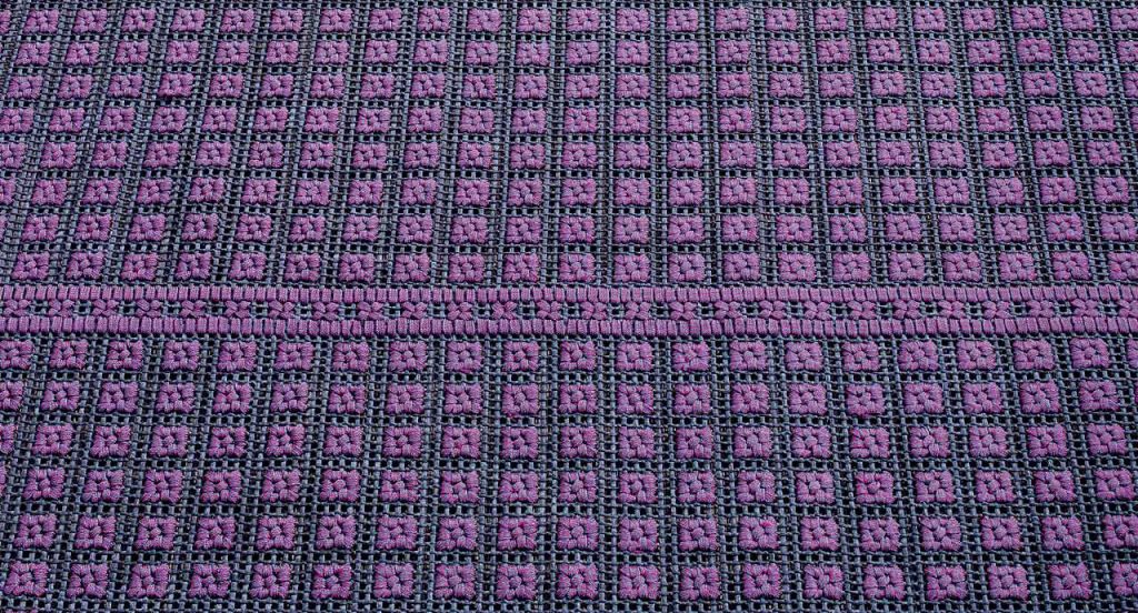 Orto rug, embriodery made of blue and purple flat braids.