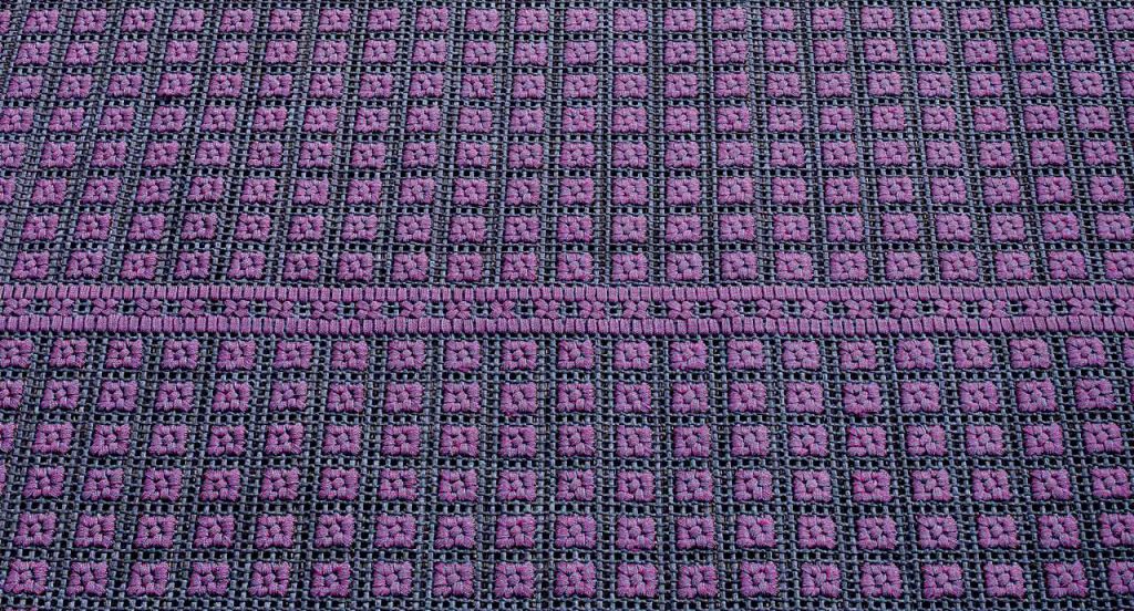 Orto rug, embriodery made of blue and purple flat braids.