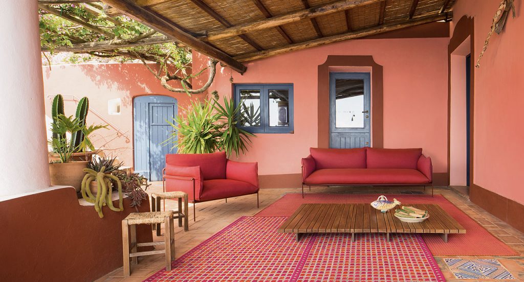 Orto rug, embriodery made of white and red flat braids in a living room.