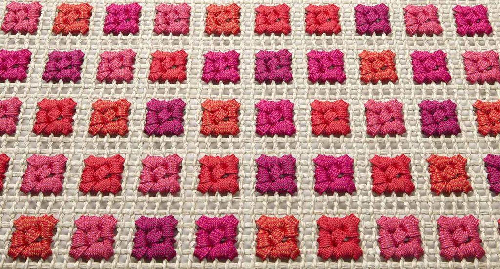 Orto rug, embriodery made of white, purple and red flat braids.