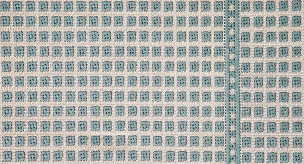 Orto rug, embriodery made of white and blue flat braids.