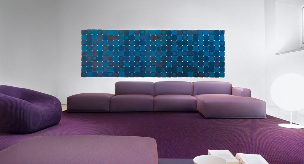 Pixel rug made with square felt elements in color blue in a living room.