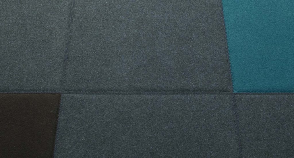 Quadri Double in grey, black, blue and green square felt modules.