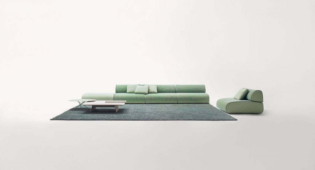 Green Ola Indoor Sofa with backrest, upholstery in fabric in a living room.