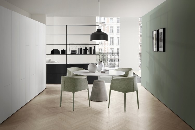 Two green Achille Armchairs in metal tubing, foamed with polyurethane rubbers, upholstered with fabric in a dining room.