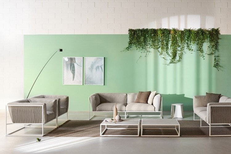 Two Arpa Low Tables, Loadbearing structure in stainless steel,Top in matt light grey calce ceramic, Structure in matt white goffered painted in a living room.