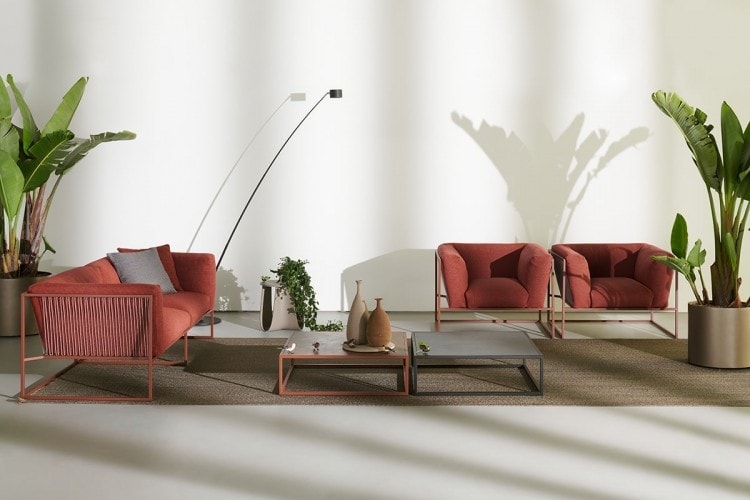 Arpa Low Table, Loadbearing structure in stainless steel, left table in red and right table in grey ceramic in a living room.