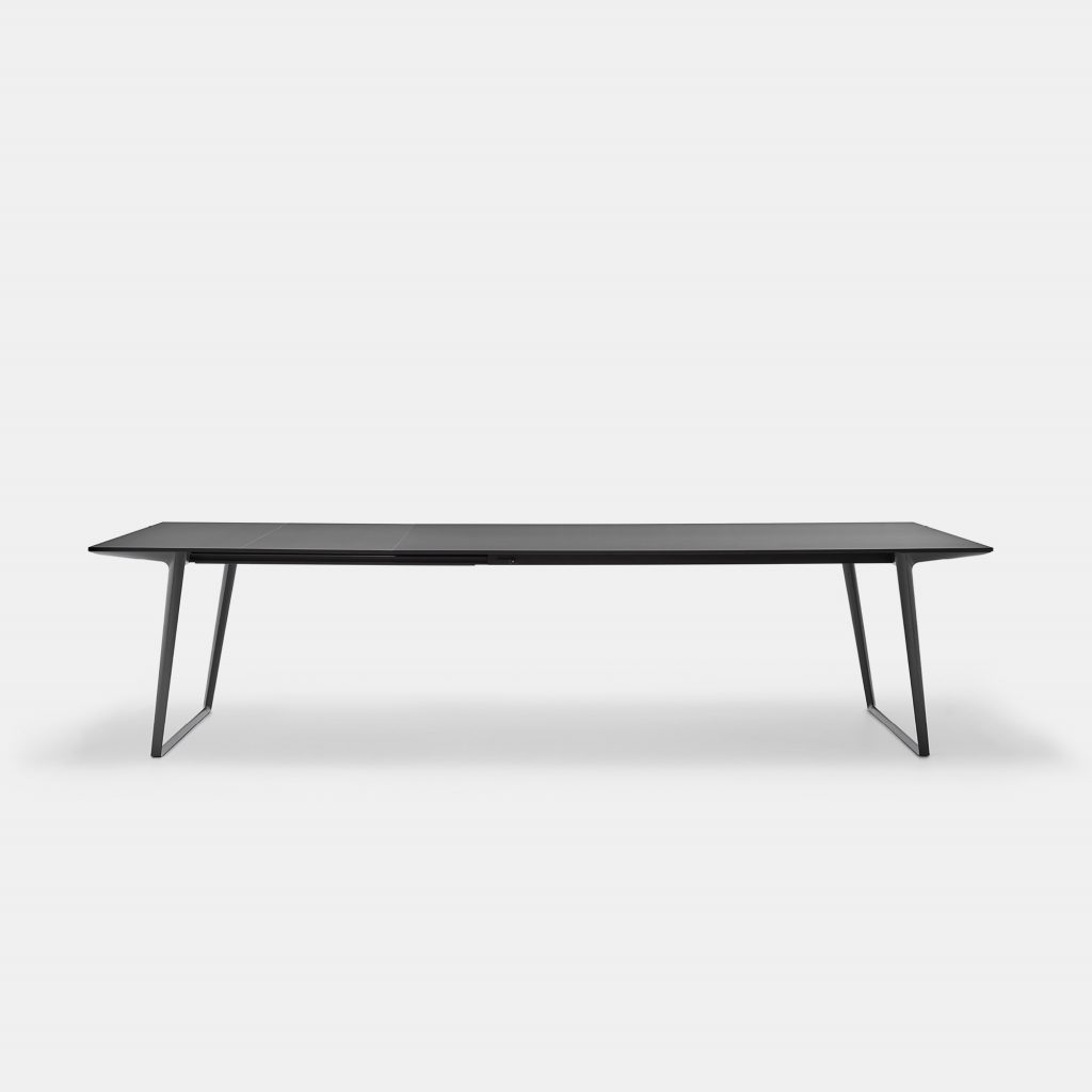 A Axy table, top and two legs in black aluminium on a white background.
