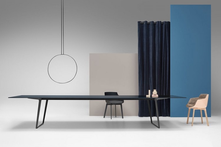 A Axy table, top and two legs in black aluminium in a dining room.