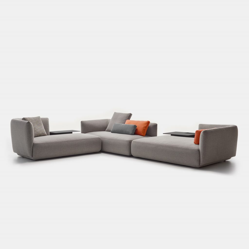 A light grey Cosy sofa made of three padded modular elements, one with the high back on de right and two on the left on a white background.