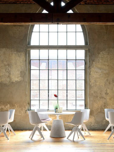 Six white Flow Chairs with four white legs on a restaurant as background