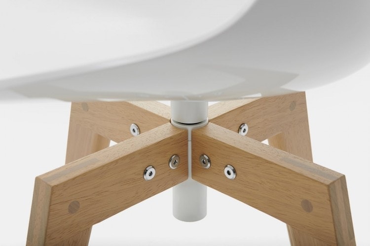 A close-up of a white Flow Chair Iroko with four-legged in natural oak on a white room background.