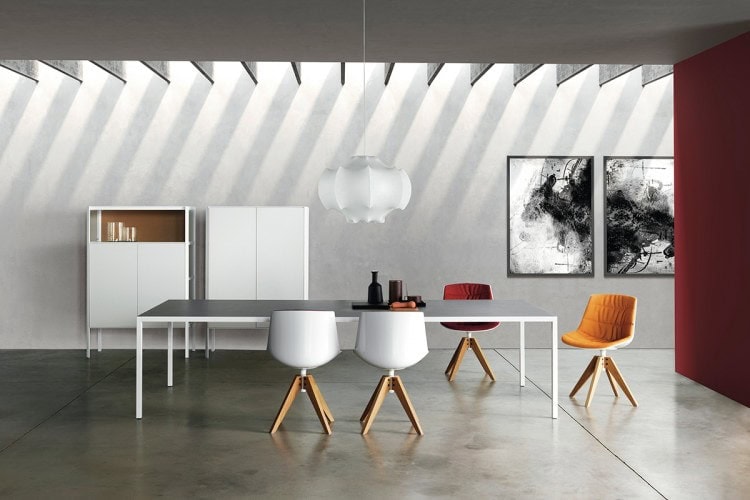 Two white Flow Chairs Padded with natural wooden bottom on a office background.