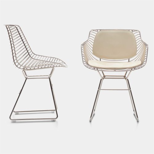 Two Flow Milo chairs made of steel core in nickel chrome finish, one with a ivory leather padding covering and backrest on a white background room.