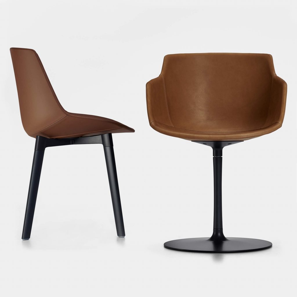 Two coffee leather chairs with a black bottom, one without arms and for legs, and one with arms and one leg on a white background