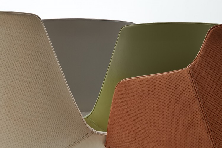 Four Flow leather chair backs, one gray, one green, one caolino and one ambra with a white background colour.