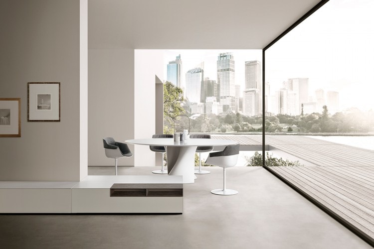Four white Flow Slim Padded chairs, grey padding with a central leg in steel on a dining room background.