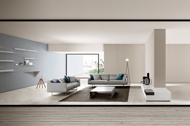 A Flow stool in matte white with four-legged base in natural oak on a living room background.