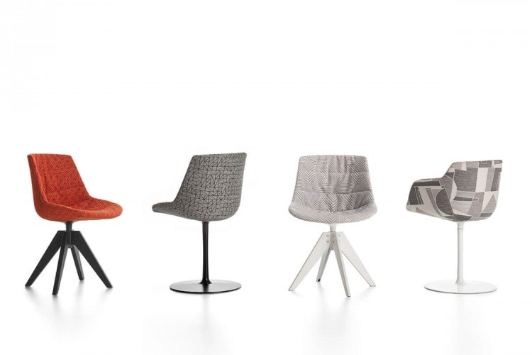 Four Flow Textile chairs, one in orange pattern with four-legged in black steel, one in grey pattern with a central leg, one in gray pattern with four-legged steel in white and one in grey pattern with a white central leg on a white background.