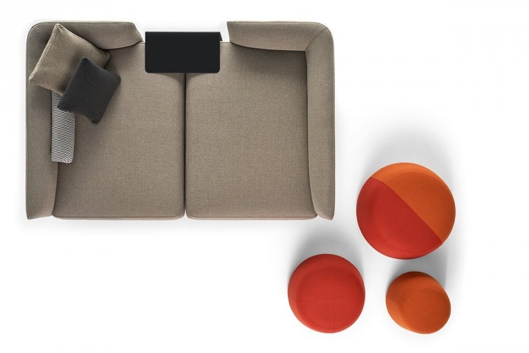 Three Fuji seats of different dimensions. Two in rust color and one in rust and orange color next to a sofa on a white background.