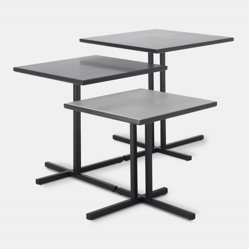 Three dark grey K Tables, tabletops in ceramic and separate frames in steel on a white background.